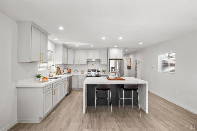 513 Verde Ave, Richmond, CA 94801 - kitchen featuring stainless steel appliances, a sink, baseboards, light countertops, and recessed lighting