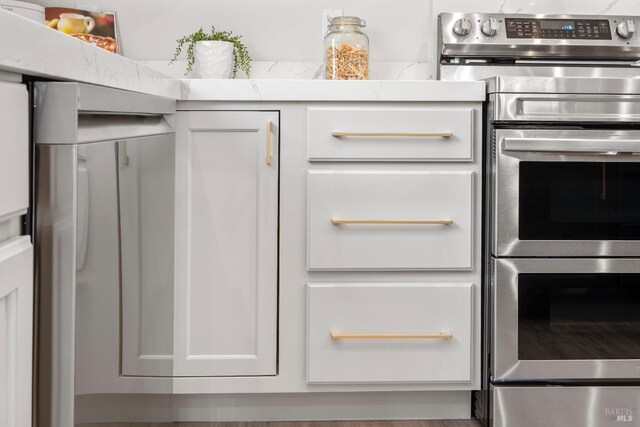 513 Verde Ave, Richmond, CA 94801 - kitchen view of range with two ovens and white cabinetry