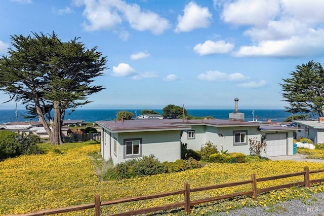 4981 Conch Ave, Bodega Bay, CA 94923 - view of front facade featuring an attached garage, a water view, and fence