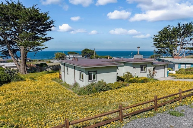 4981 Conch Ave, Bodega Bay, CA 94923 - view of front facade featuring a water view, fence, a garage, and stucco siding
