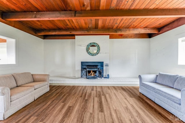 4981 Conch Ave, Bodega Bay, CA 94923 - living room with wood finished floors, beamed ceiling, wood ceiling, healthy amount of natural light, and a brick fireplace