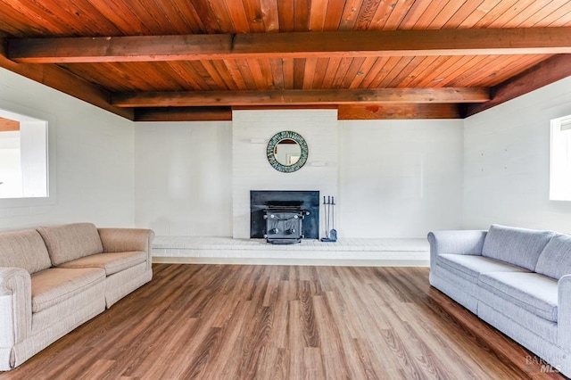 4981 Conch Ave, Bodega Bay, CA 94923 - living room featuring beam ceiling, wooden ceiling, wood finished floors, and a wood stove