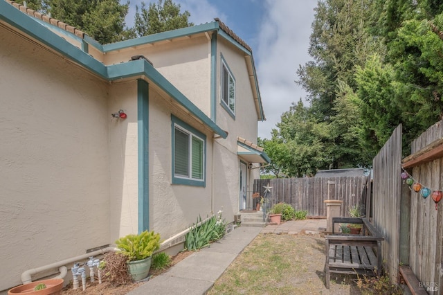 47 Francis Cir, Rohnert Park, CA 94928 - view of side of home featuring stucco siding, fence, and a tile roof