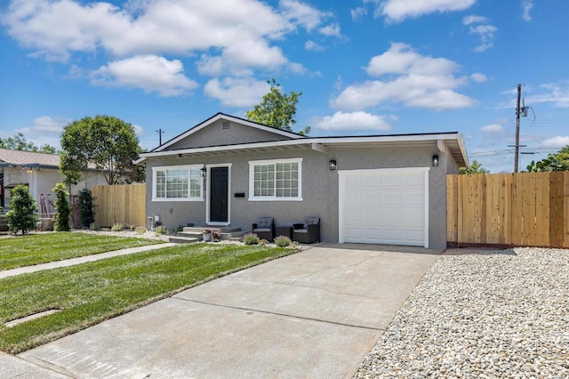 view of front of property with an attached garage, stucco siding, and concrete driveway