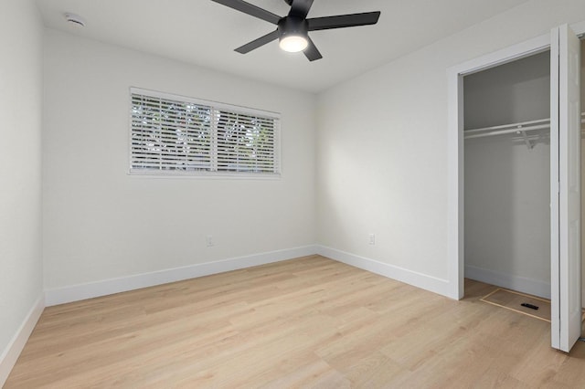 unfurnished bedroom with light wood-style flooring, baseboards, a closet, and a ceiling fan
