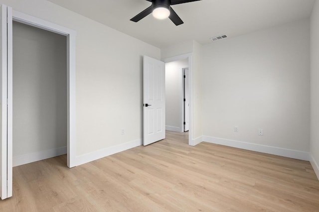 unfurnished bedroom featuring light wood-type flooring, baseboards, and ceiling fan