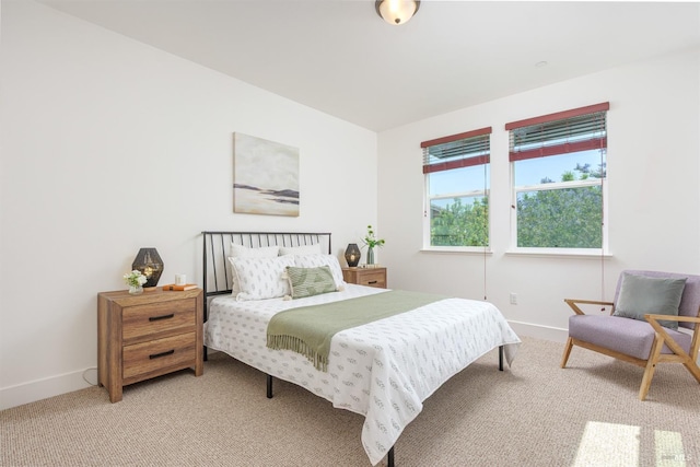 carpeted bedroom featuring baseboards