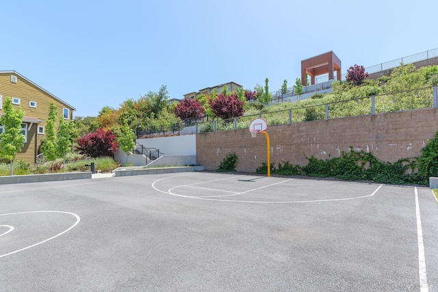 view of basketball court with community basketball court and fence