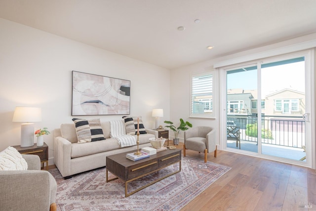 living room featuring light wood-style flooring and recessed lighting