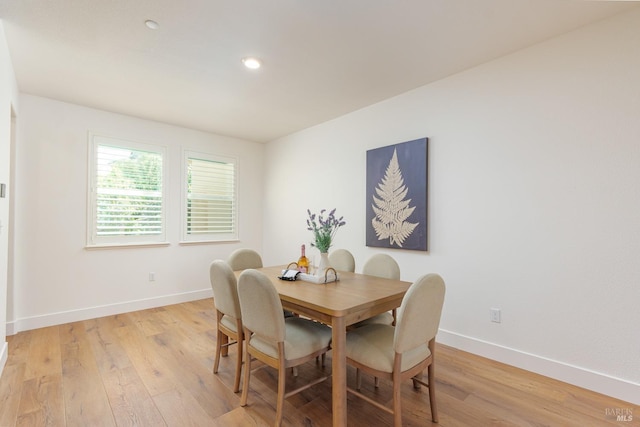 dining space featuring baseboards, light wood-style floors, and recessed lighting