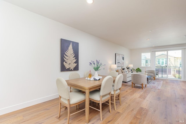dining area featuring light wood-style flooring, baseboards, and recessed lighting
