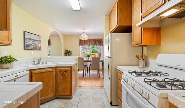 830 Chardonnay Cir, Petaluma, CA 94954 - kitchen featuring white appliances, under cabinet range hood, a peninsula, and tile counters