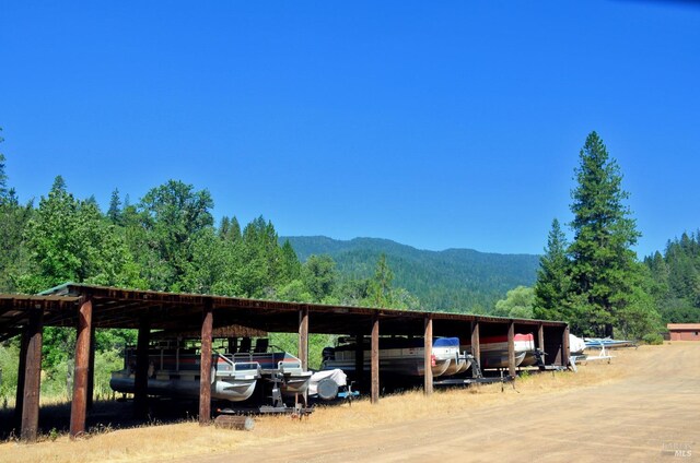 3320 Booth Way, Potter Valley, CA 95469 - view of car parking with a mountain view, a forest view, a carport, and dirt driveway