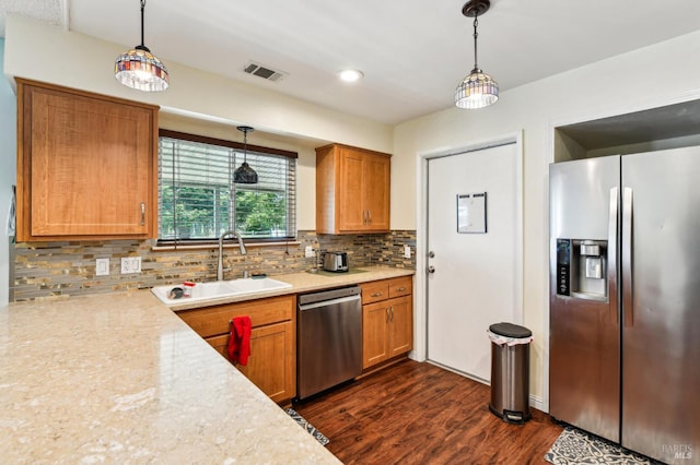 134 Lassen Cir, Vacaville, CA 95687 - kitchen featuring appliances with stainless steel finishes, a sink, light countertops, brown cabinetry, and recessed lighting