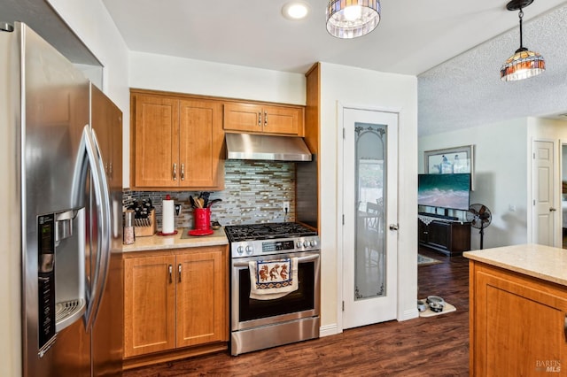 134 Lassen Cir, Vacaville, CA 95687 - kitchen featuring appliances with stainless steel finishes, extractor fan, brown cabinets, tasteful backsplash, and dark wood-type flooring