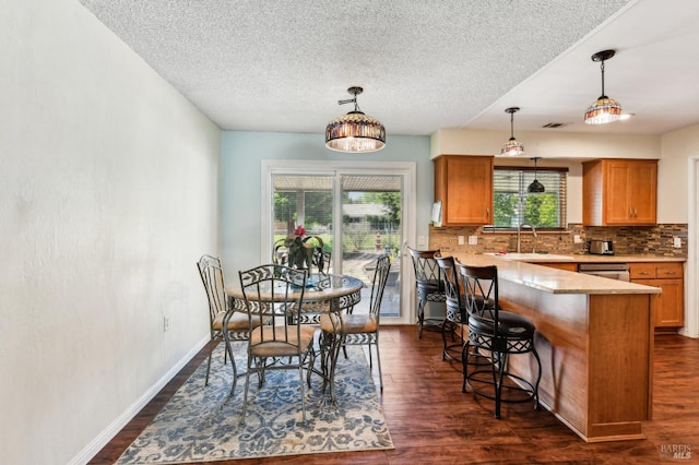 134 Lassen Cir, Vacaville, CA 95687 - dining room with dark wood-type flooring, a textured ceiling, and baseboards