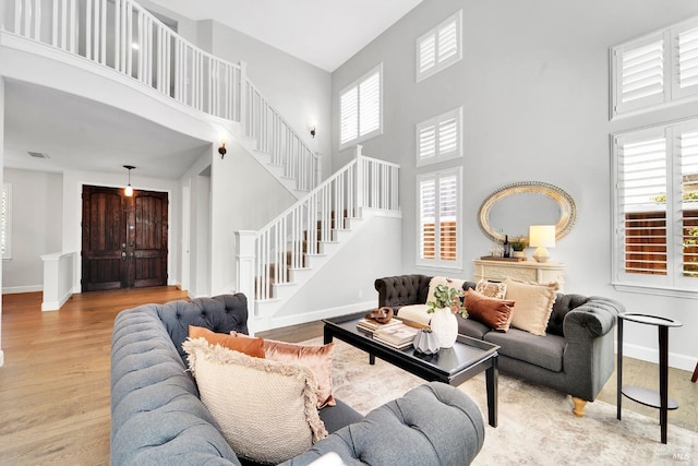 653 Robinson Way, Benicia, CA 94510 - living area with a high ceiling, baseboards, stairway, and wood finished floors