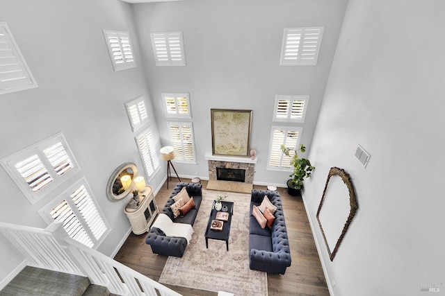 653 Robinson Way, Benicia, CA 94510 - living area featuring a towering ceiling, baseboards, a fireplace, and wood finished floors
