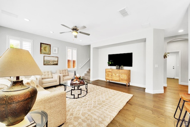 653 Robinson Way, Benicia, CA 94510 - living room with arched walkways, wood finished floors, recessed lighting, ceiling fan, and baseboards