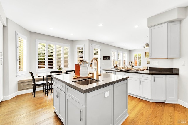 653 Robinson Way, Benicia, CA 94510 - kitchen featuring a sink, light wood finished floors, dark countertops, healthy amount of natural light, and recessed lighting