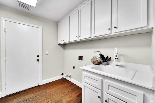 653 Robinson Way, Benicia, CA 94510 - laundry area featuring washer hookup, hookup for an electric dryer, dark wood-type flooring, baseboards, and cabinet space
