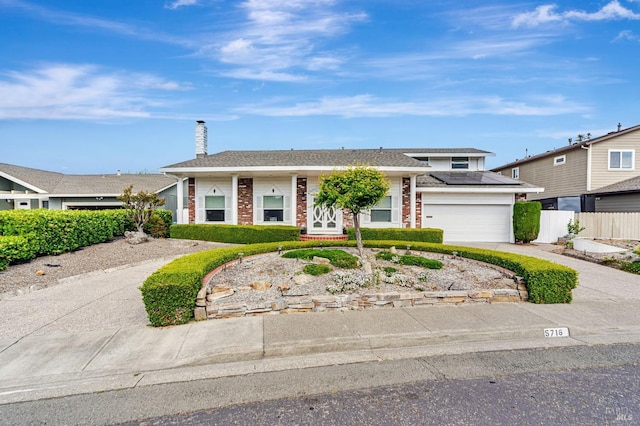 5716 Dexter Cir, Rohnert Park, CA 94928 - view of front of property with brick siding, solar panels, fence, and concrete driveway