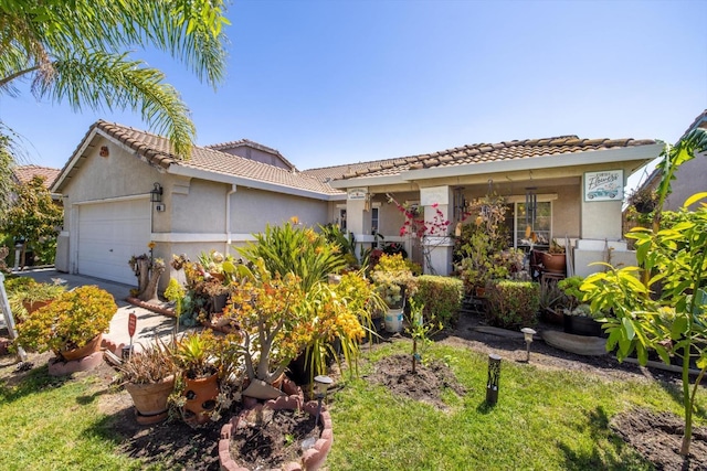 view of front of property with an attached garage, stucco siding, and a tile roof