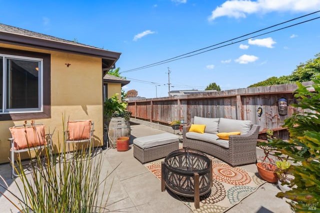 view of patio featuring a fenced backyard and an outdoor living space with a fire pit