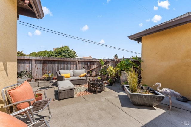 view of patio / terrace featuring an outdoor living space with a fire pit and a fenced backyard