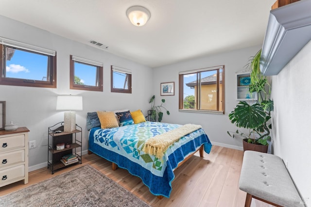 bedroom featuring baseboards and wood finished floors
