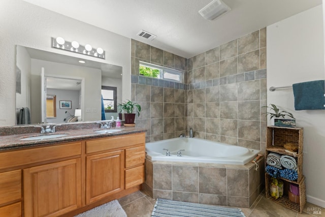 full bathroom with a garden tub, tile patterned flooring, and double vanity