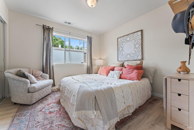 bedroom featuring light wood-type flooring and baseboards
