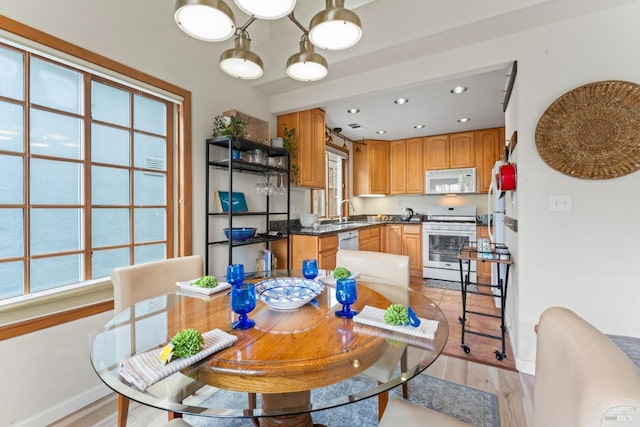 dining area featuring light wood-type flooring, baseboards, and recessed lighting