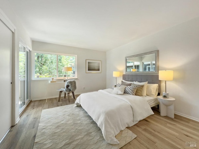 bedroom featuring wood finished floors and baseboards