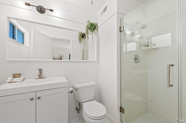 bathroom featuring toilet, a shower stall, and vanity