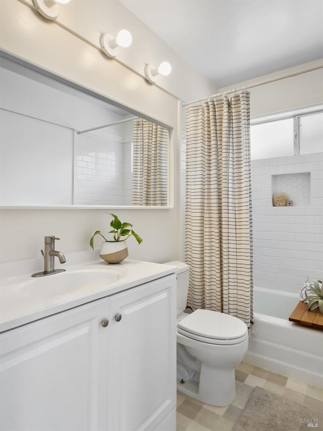 bathroom featuring toilet, vanity, and shower / tub combo