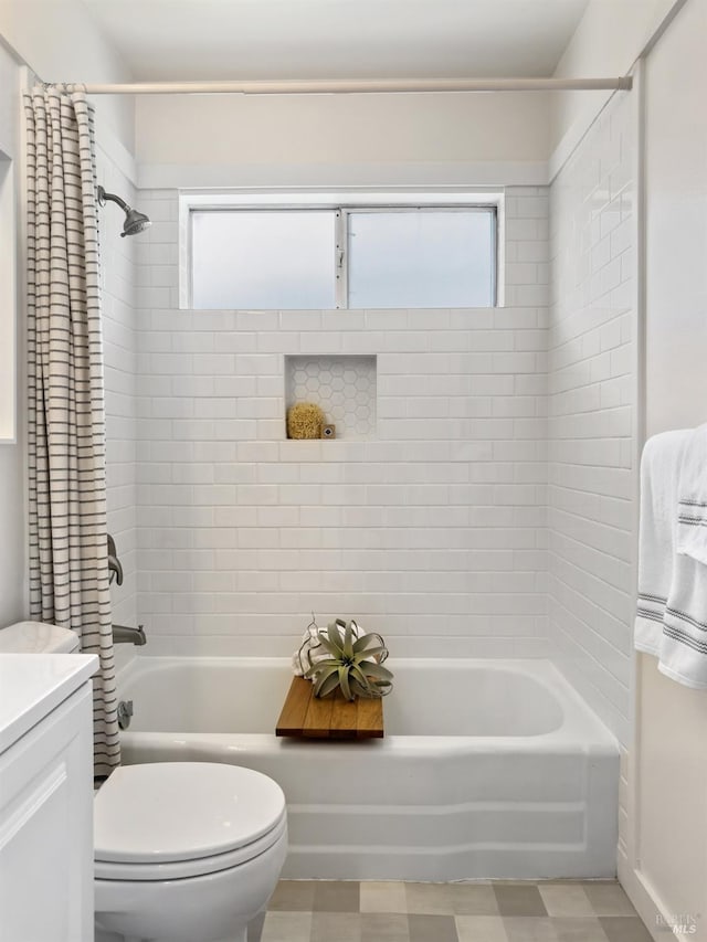bathroom with shower / bath combo with shower curtain, toilet, and vanity