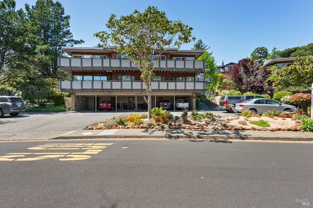 view of building exterior featuring uncovered parking