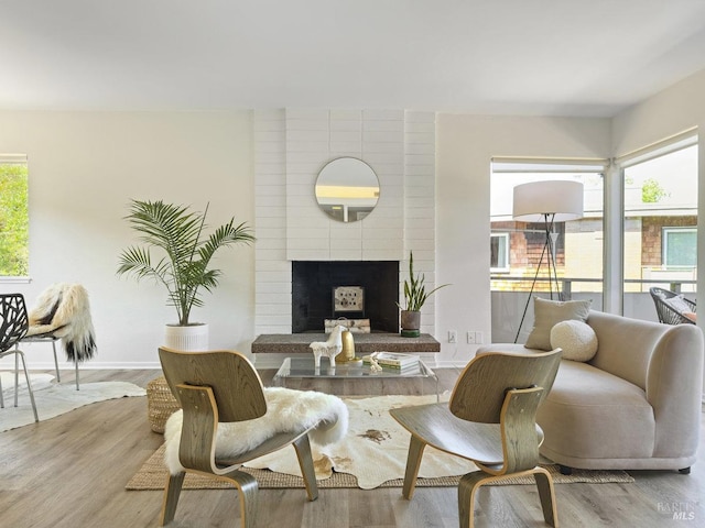 dining room featuring wood finished floors and a fireplace