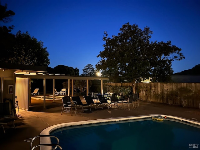 view of swimming pool with a patio area and fence