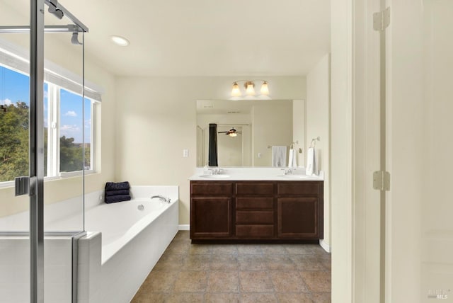 212 Via Del Sol, Vacaville, CA 95687 - bathroom with double vanity, a garden tub, ceiling fan, recessed lighting, and baseboards