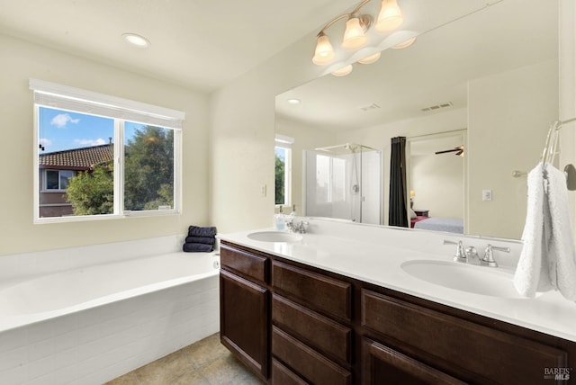 212 Via Del Sol, Vacaville, CA 95687 - ensuite bathroom featuring plenty of natural light, a garden tub, double vanity, tile patterned flooring, and recessed lighting