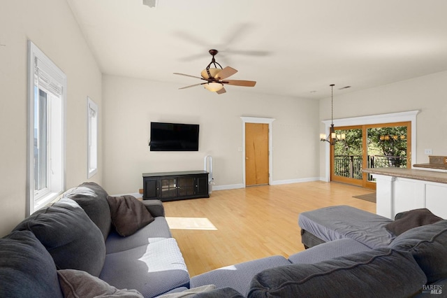 1126 Rimrock Dr, Napa, CA 94558 - living room with light wood-style flooring, a ceiling fan, a chandelier, and baseboards