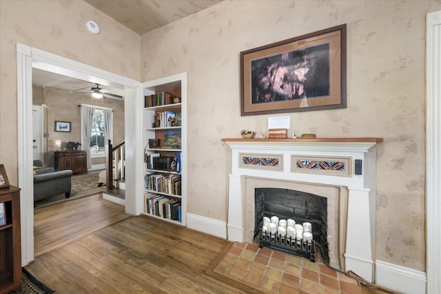 25107 Main St, Capay, CA 95607 - living area with a fireplace, wood finished floors, wallpapered walls, baseboards, and ceiling fan