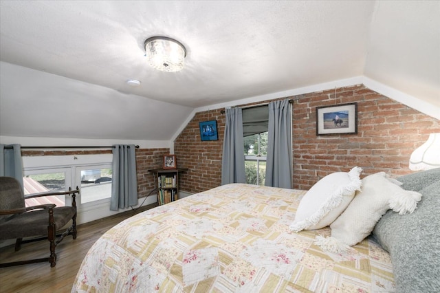 25107 Main St, Capay, CA 95607 - bedroom with vaulted ceiling, wood finished floors, and brick wall