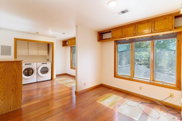 3756 Cano Ct, Napa, CA 94558 - laundry area featuring washing machine and dryer, light wood-type flooring, baseboards, and cabinet space