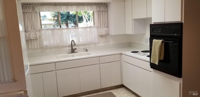 2324 W Park Ave, Napa, CA 94558 - kitchen featuring black oven, a sink, white electric stovetop, white cabinets, and light countertops