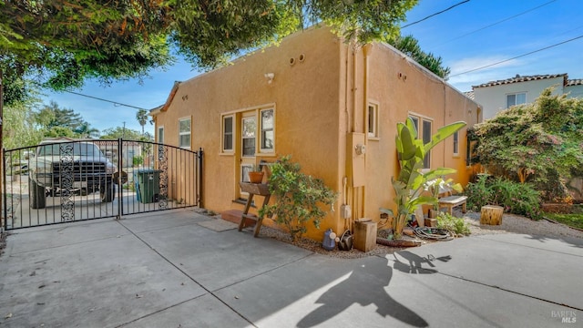 1302 Illinois St, Vallejo, CA 94590 - view of side of property featuring a gate, stucco siding, and central air condition unit
