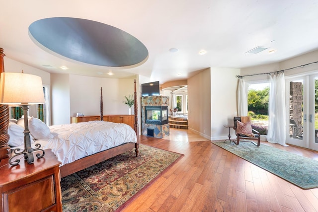 27681 Mace Blvd, Davis, CA 95618 - bedroom featuring access to exterior, light wood finished floors, recessed lighting, baseboards, and a multi sided fireplace