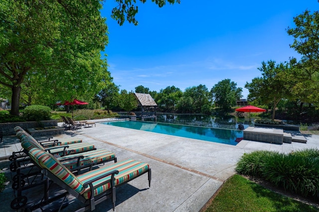 27681 Mace Blvd, Davis, CA 95618 - view of pool featuring a patio area, an infinity pool, and view of wooded area